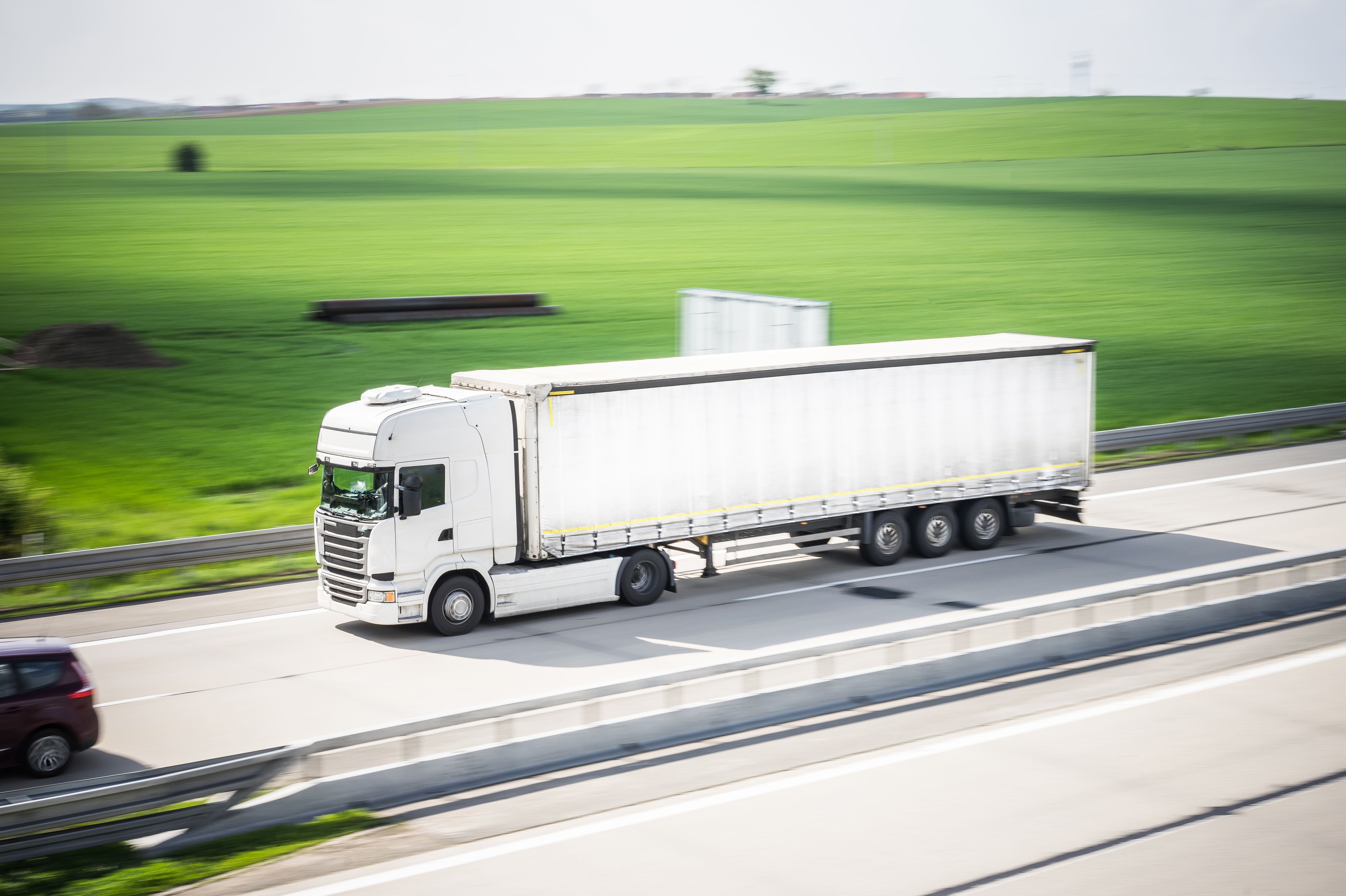 white-tir-truck-in-motion-driving-on-highway-picjumbo-com